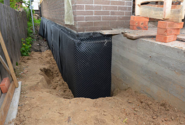 Happy homeowners after waterproofing job in Thayer